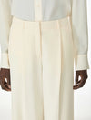 Woman wearing cream trousers close up