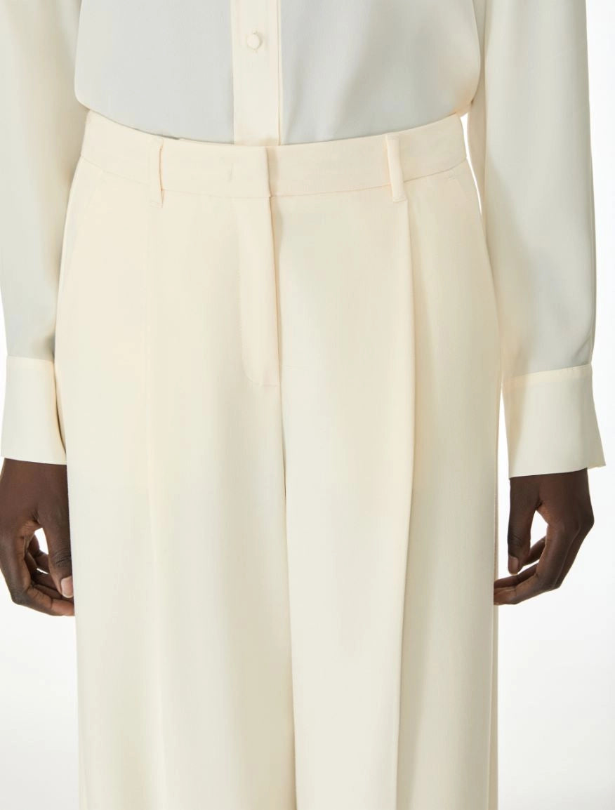Woman wearing cream trousers close up