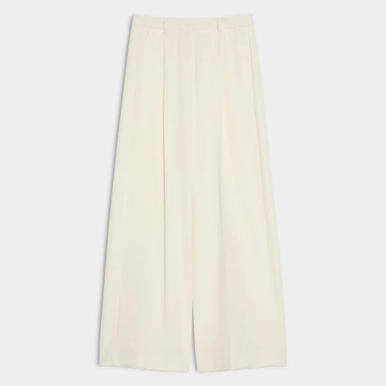 A pair of off-white wide-leg cropped trousers with a high waist and front pleats, displayed flat against a light gray background.