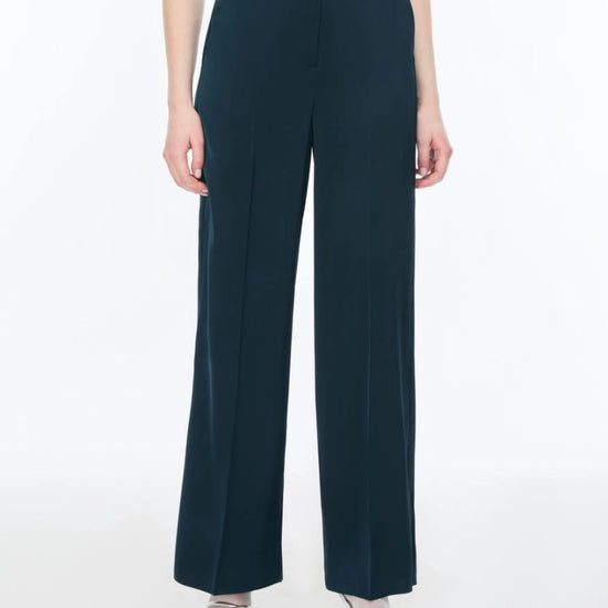Navy blue wide-leg pants worn by a person on a white background