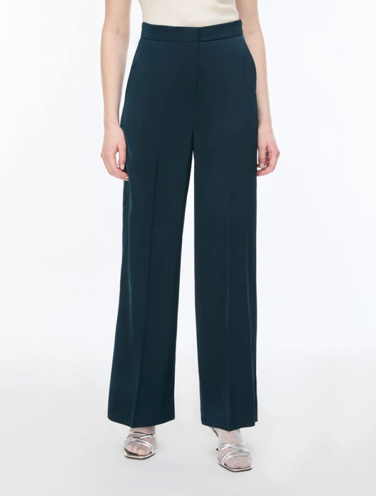 Navy blue wide-leg pants worn by a person on a white background