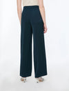 woman wearing Blue satin trousers on a white background rear view