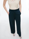 woman wearing Blue satin trousers  and white cami on a white background