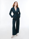 Woman wearing Blue satin trousers and matching blazer on a white background