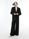 woman wearing black wide leg trousers with blazer