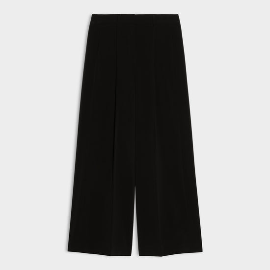 black wide leg pleated jeans on white background