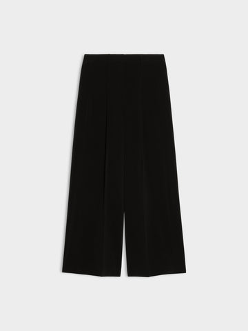 black wide leg pleated jeans on white background