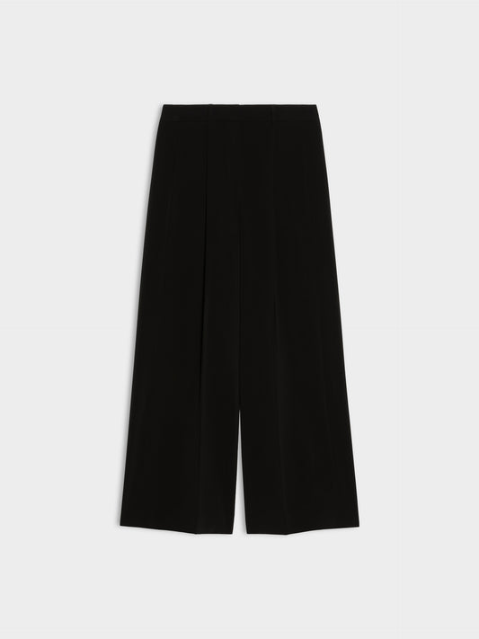 black wide leg pleated jeans on white background