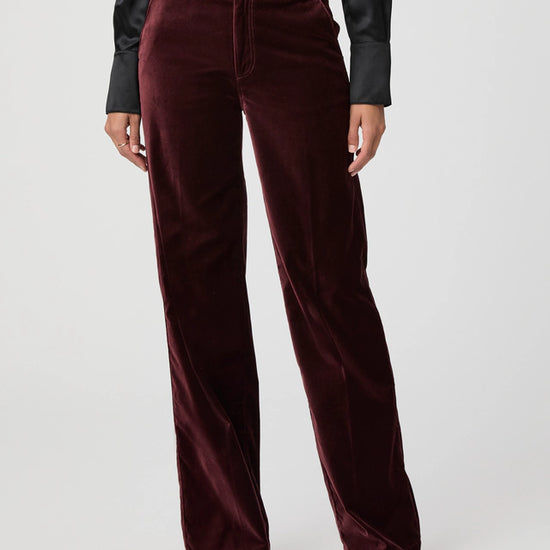 Close up of dark red velvet trousers