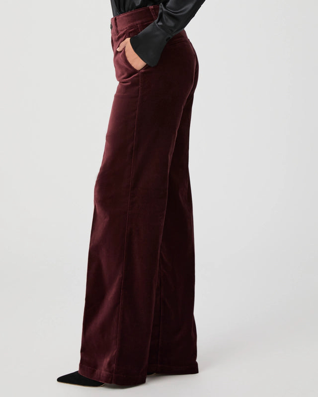 Side view of dark red velvet trousers