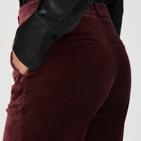 Close up of pocket detail on red velvet trousers