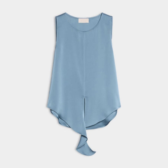 A light blue sleeveless top with a round neckline and an asymmetrical draped hem, shown flat against a light gray background.
