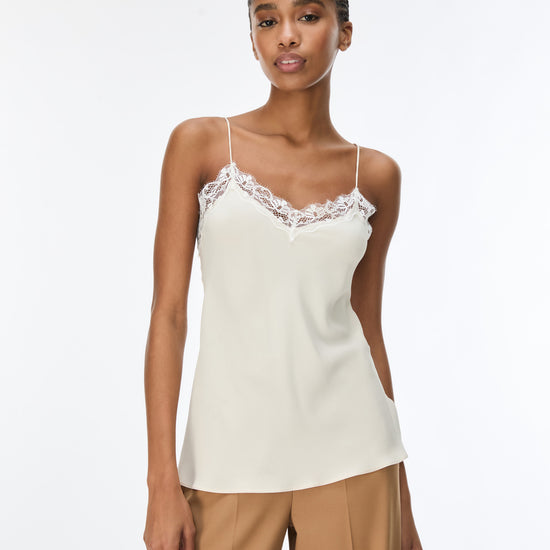 woman wearing cream lace cami with brown trousers 
