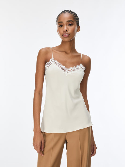 woman wearing cream lace cami with brown trousers 