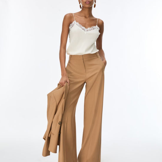 woman wearing cream lace cami with brown trousers  full outfit 