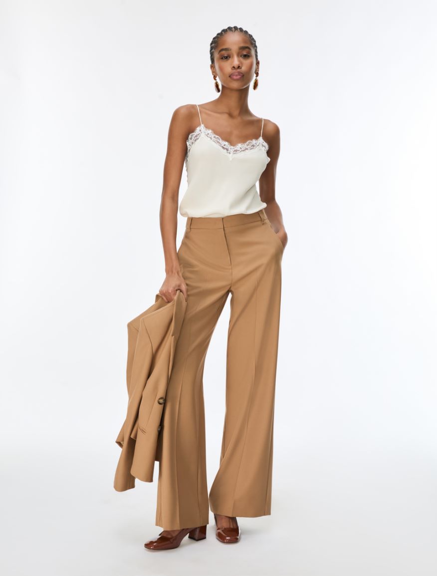 woman wearing cream lace cami with brown trousers  full outfit 