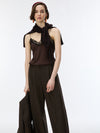 A model wearing a dark brown sleeveless top with lace trim and a matching draped scarf, paired with dark brown pleated wide-leg trousers, against a plain white studio background.