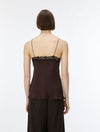 A model shown from the back wearing a dark brown camisole top with black lace trim at the neckline and matching dark pleated trousers, against a plain white studio background.