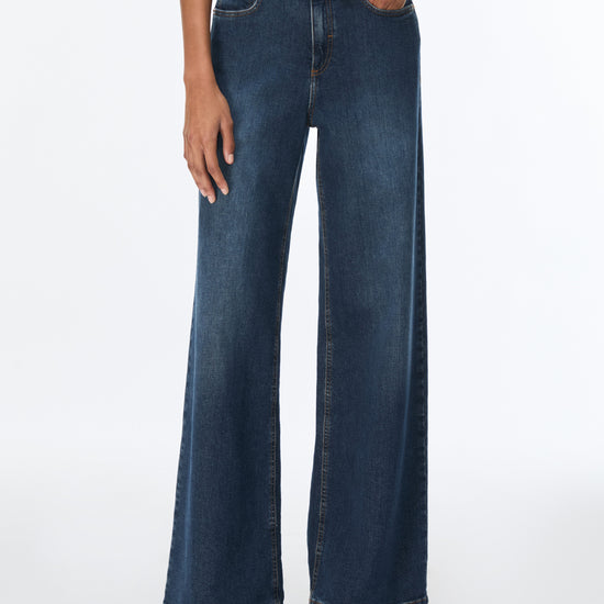 woman wearing blue jeans and brown top