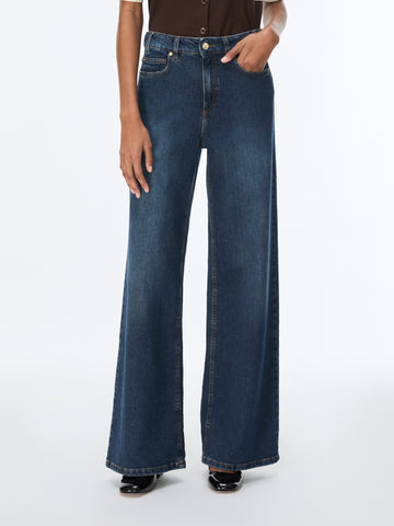 woman wearing blue jeans and brown top