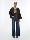 woman wearing brown jeans and brown jacket 