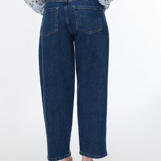Person wearing blue jeans on a white background