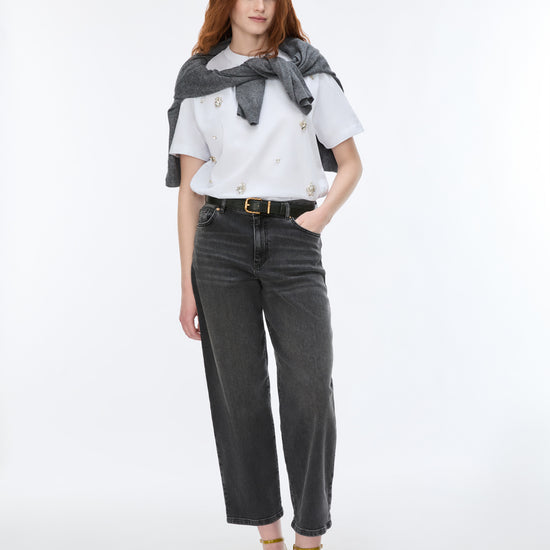 woman wearing grey barrel leg jeans and white t shirt 