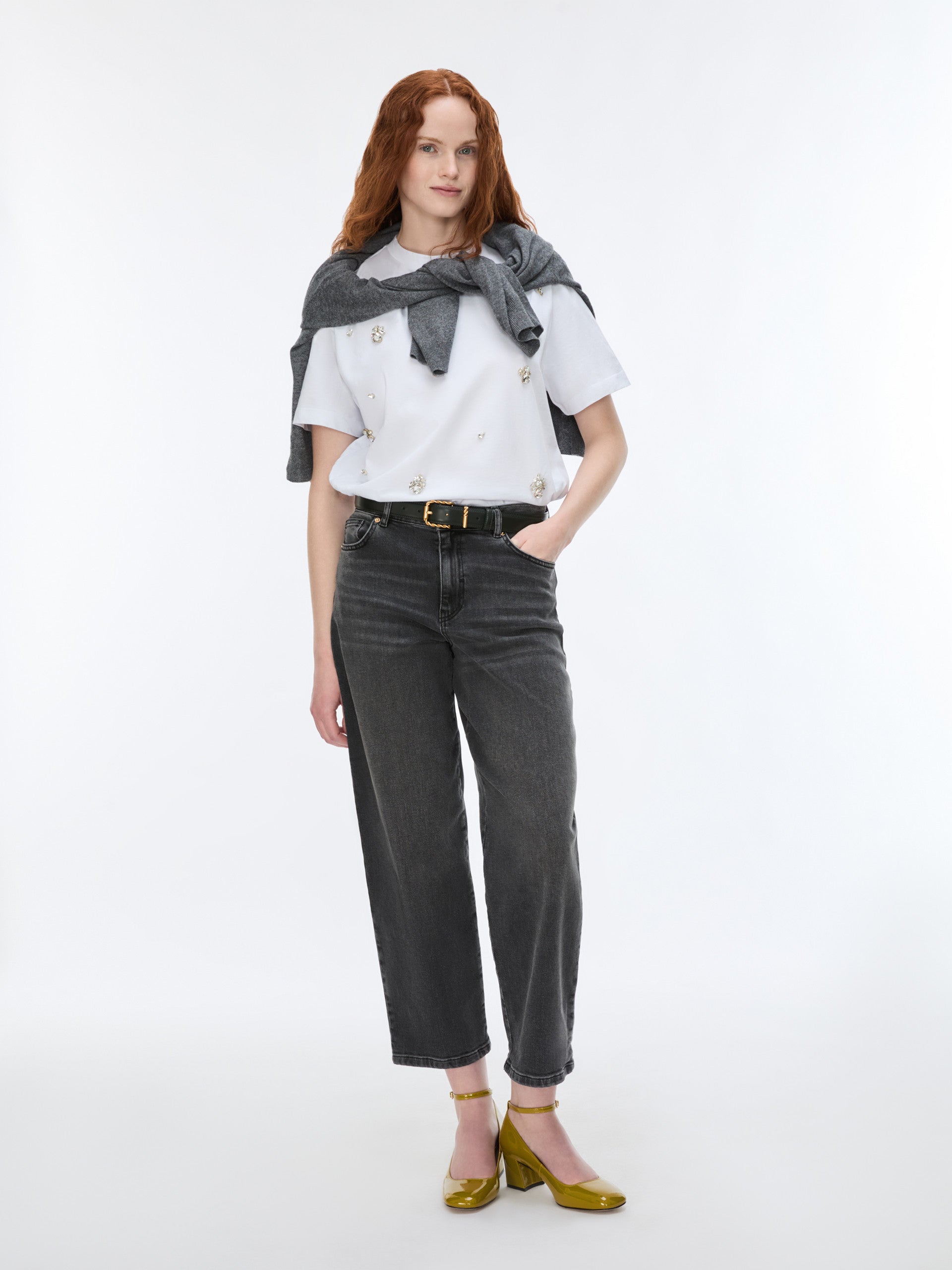 woman wearing grey barrel leg jeans and white t shirt 