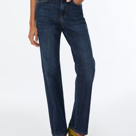 woman wearing blue jeans and brown top
