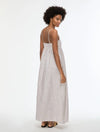 Woman wearing a long striped dress on a white background