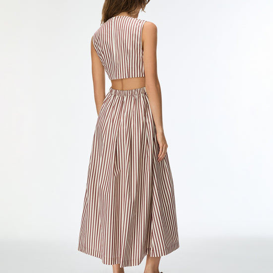 Woman wearing a striped two-piece outfit on a white background