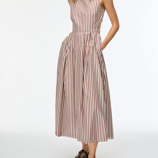 Woman wearing a striped dress on a white background