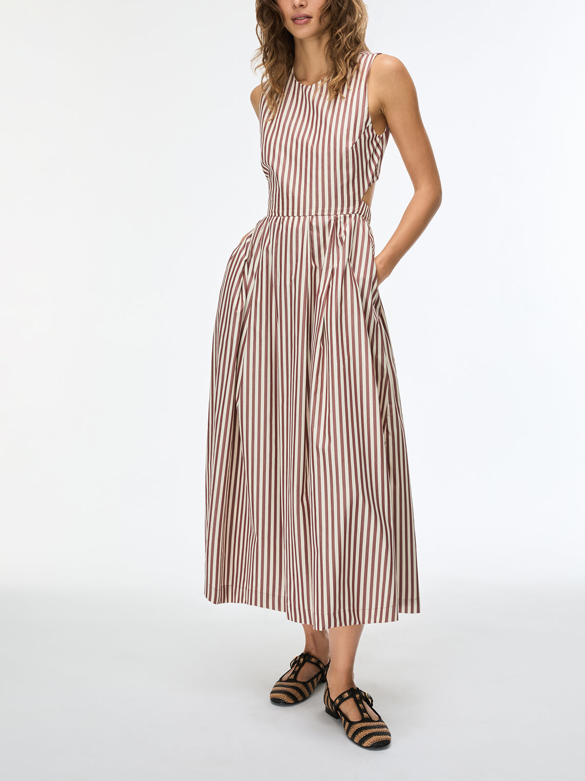 Woman wearing a striped dress on a white background