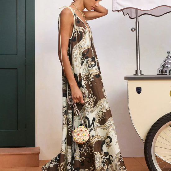 Side profile of model wearing brown midi dress
