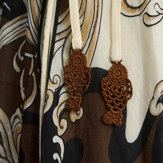 close up of brown pattern on dress