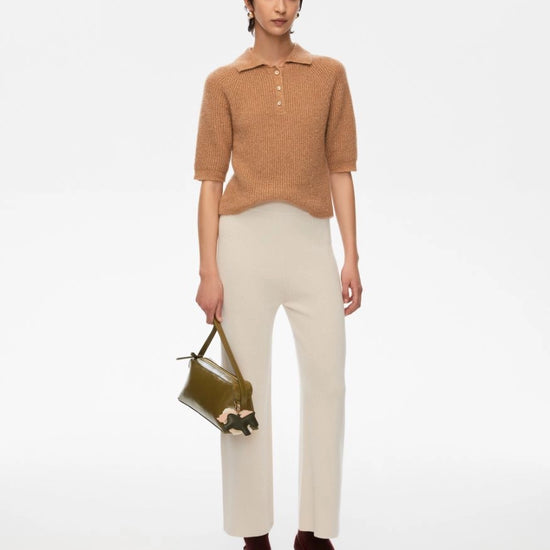 short sleeve knitted polo style shirt with 3 buttons and a slight shimmer from iblues model shot