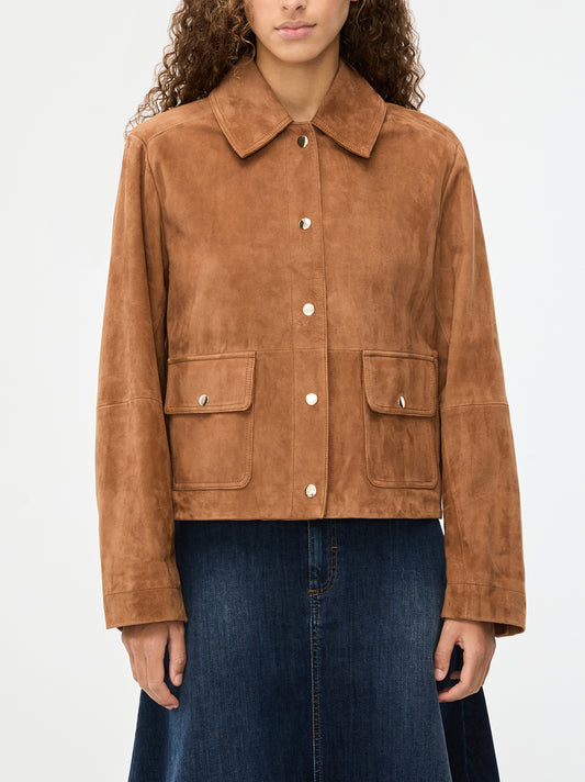 Brown suede jacket worn by a person on a white background