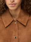 Close-up of a brown suede jacket with a collar and buttons.