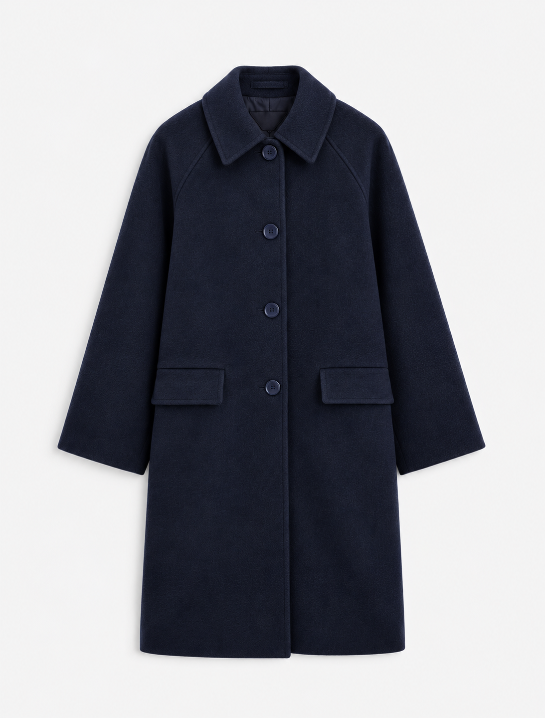 A woman modeling a dark navy blue wool-blend coat with front buttons, paired with light blue jeans and brown shoes, standing against a plain white studio background.