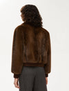 Person wearing a brown fur jacket on a white background rear view