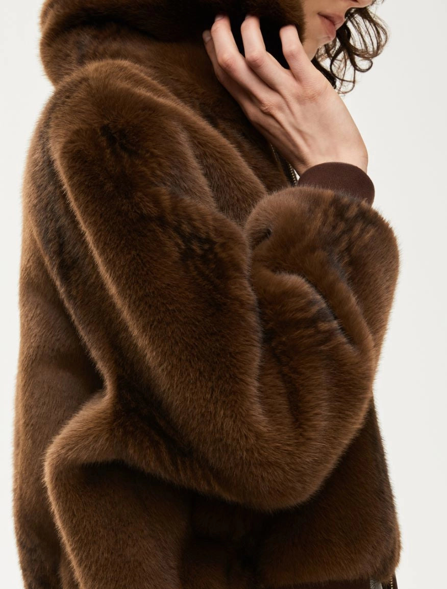Brown fur coat with a blurred background sleeve detail