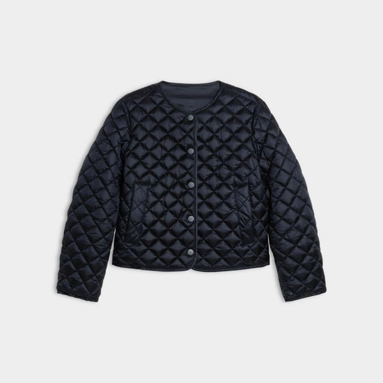 navy quilted coat on white background