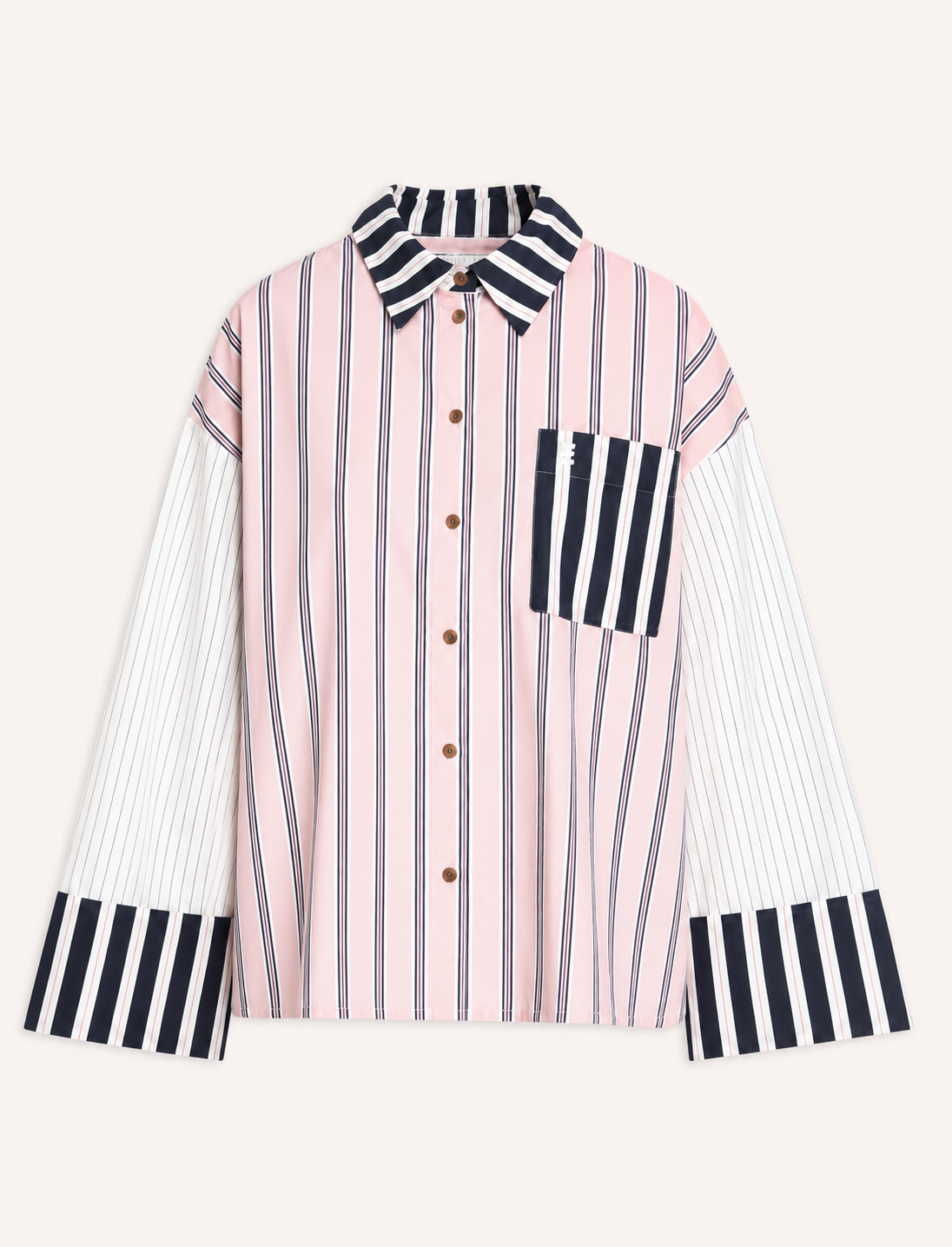 A long-sleeve button-up shirt with a pink and white vertical stripe body, contrasting black and white striped collar, chest pocket, and cuffs, displayed on a light cream background.