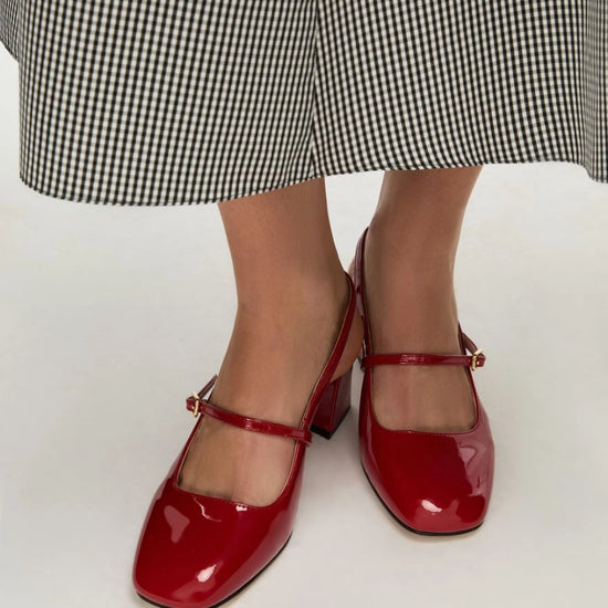 red patent leather square toe mary jane heels with slingback and strap over the foot from iblues model shot