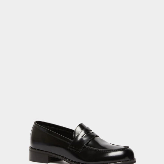 black leather loafers with small heel and metallic dot detailing along the edging form iblues front view