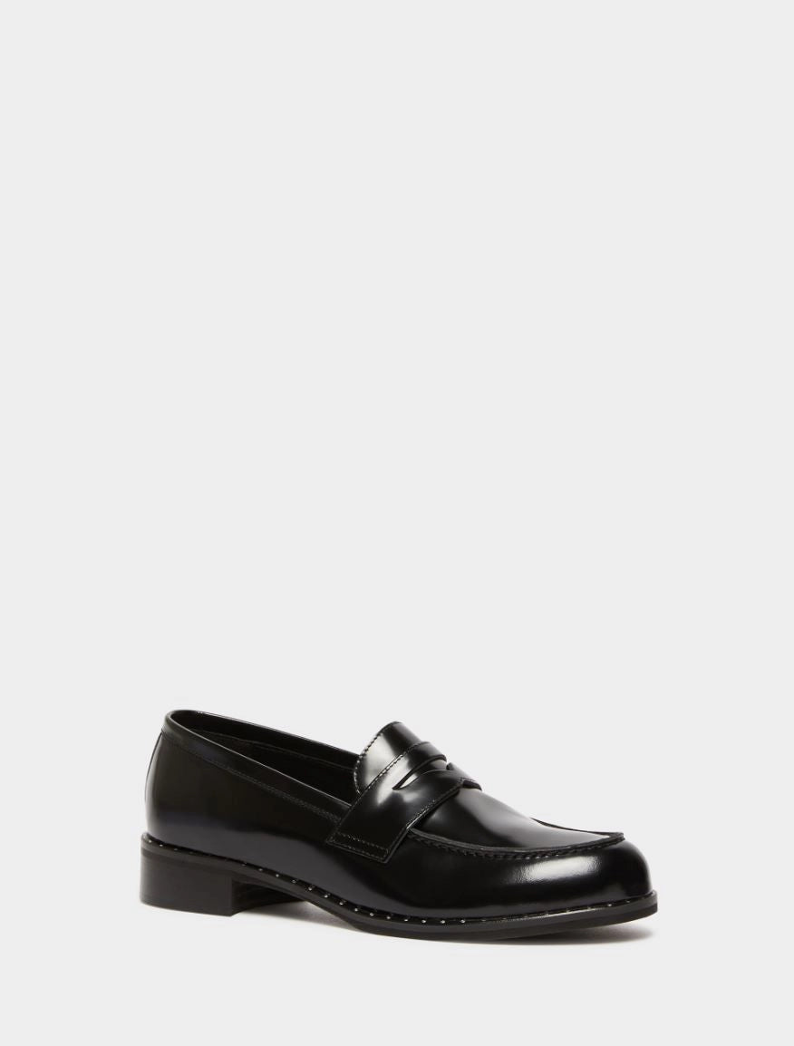 black leather loafers with small heel and metallic dot detailing along the edging form iblues front view