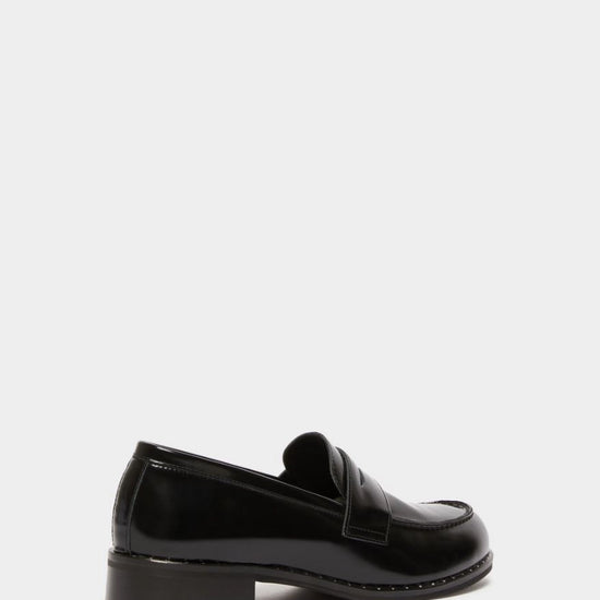 black leather loafers with small heel and metallic dot detailing along the edging form iblues rear view