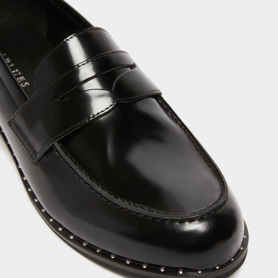 black leather loafers with small heel and metallic dot detailing along the edging form iblues front view close up