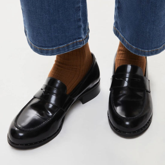 black leather loafers with small heel and metallic dot detailing along the edging form iblues model shot