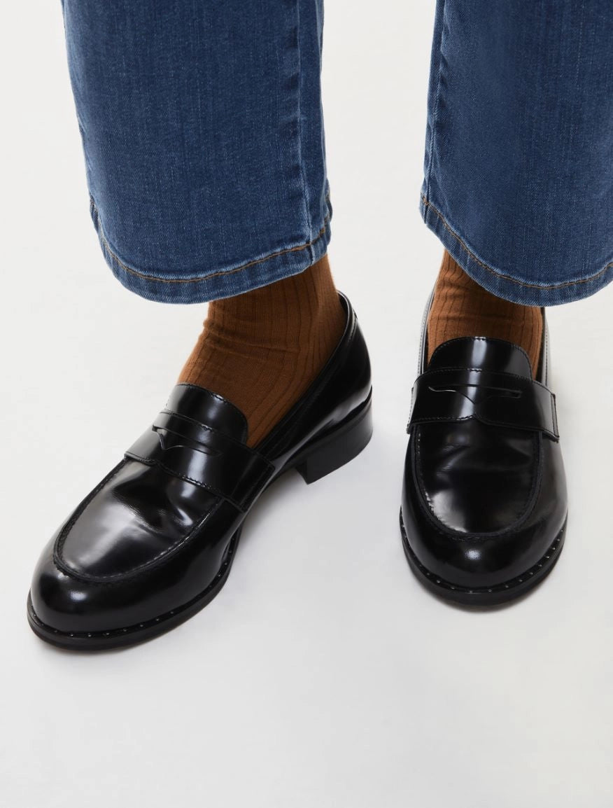 black leather loafers with small heel and metallic dot detailing along the edging form iblues model shot
